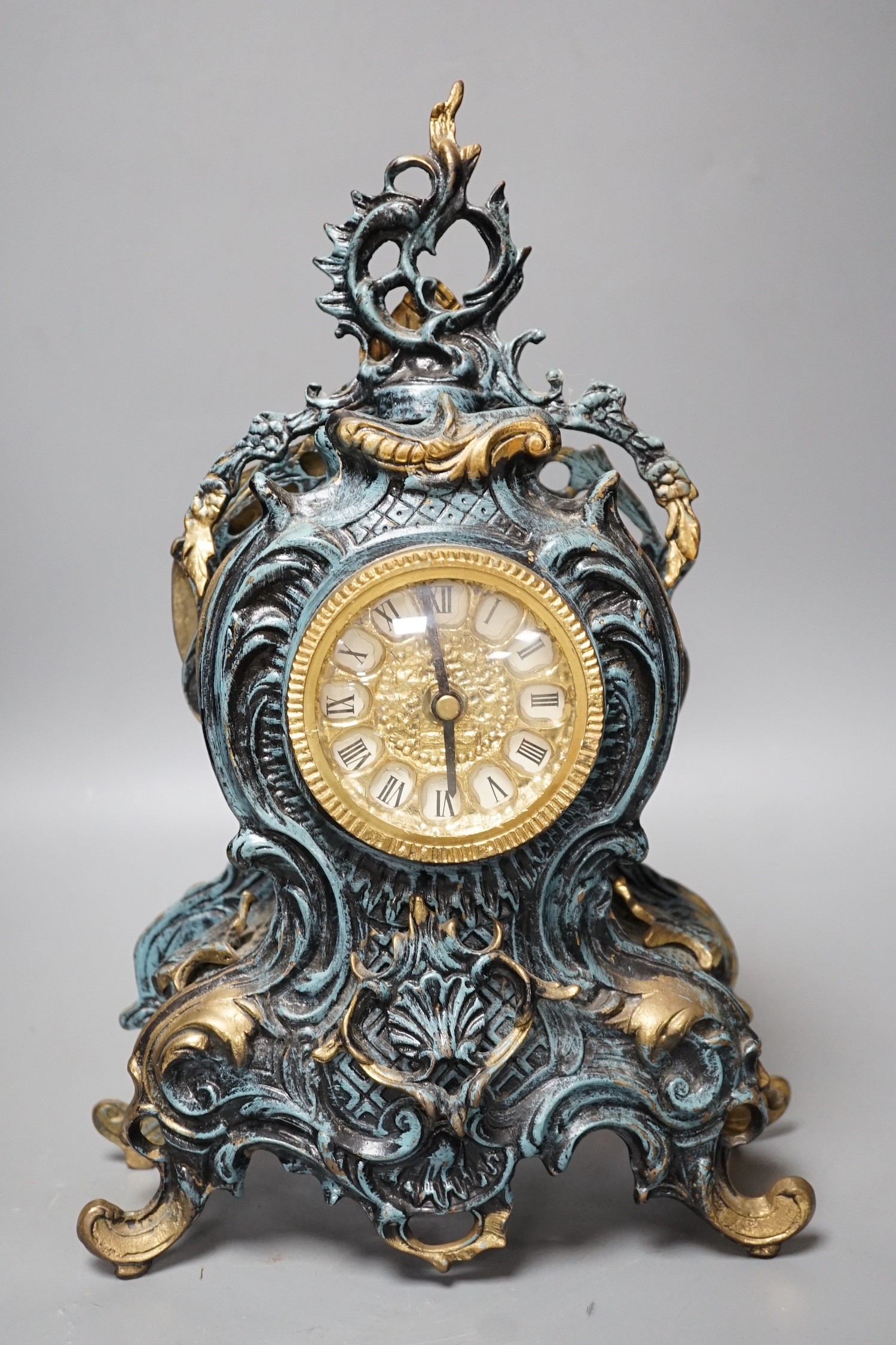 A Louis XV style spelter and parcel gilt mantel timepiece, 37cm